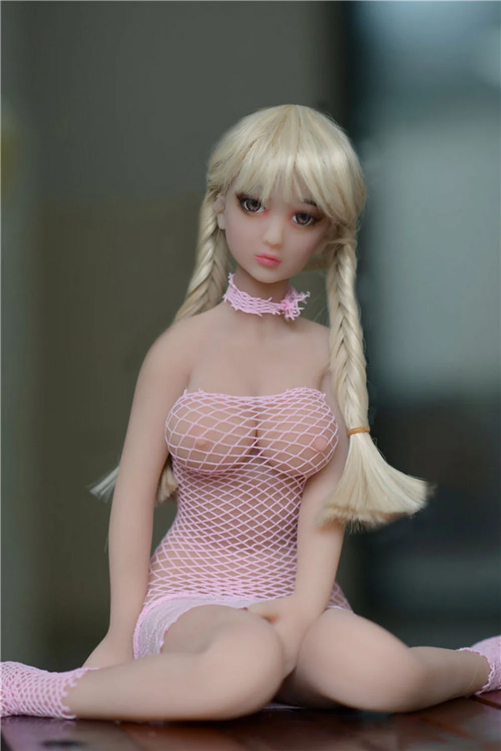 Mini sex doll sitting with legs apart