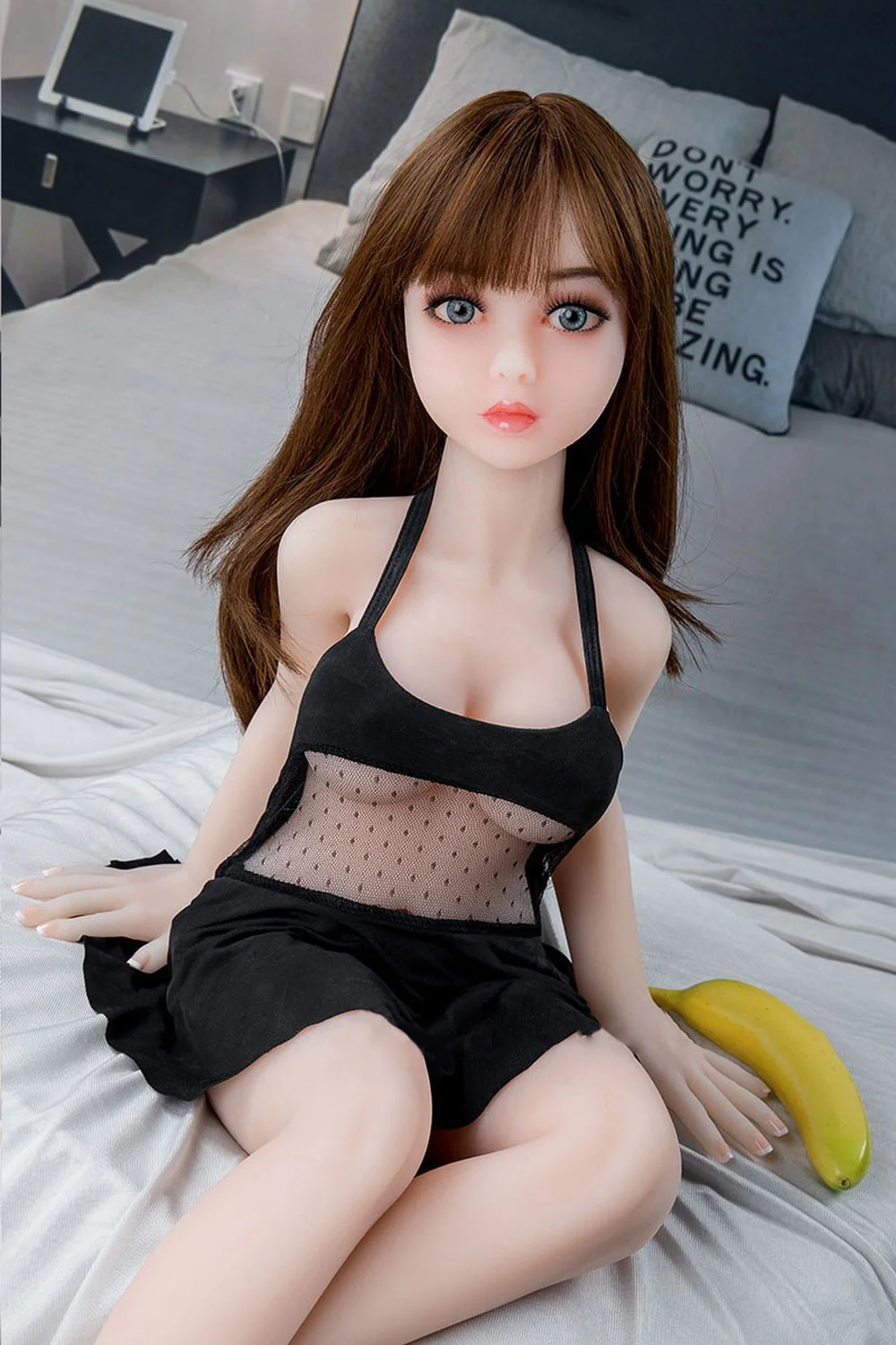 Mini sex doll with banana next to it