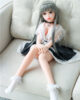 Mini sex doll with legs bent and hands on knees