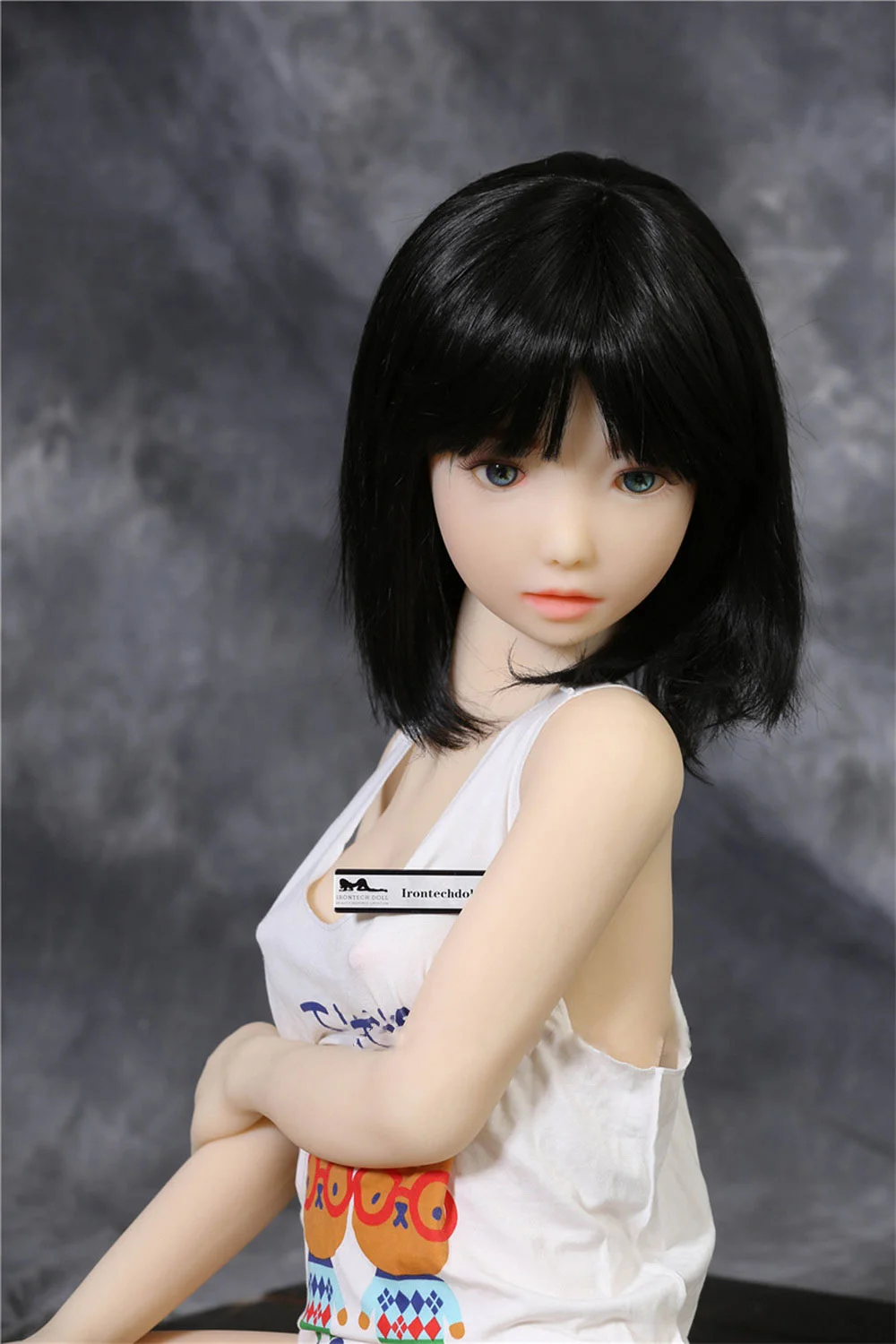 Mini sex doll with one hand on the chest