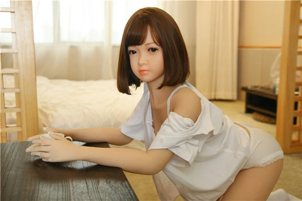 Sex doll holding a cup in both hands