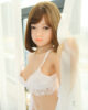 Sex doll with hand touching curtain