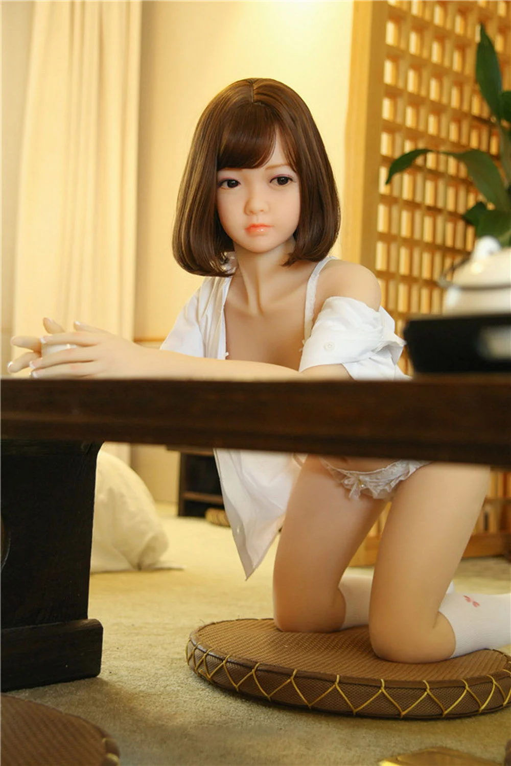 Sex doll with legs kneeling on the cushion