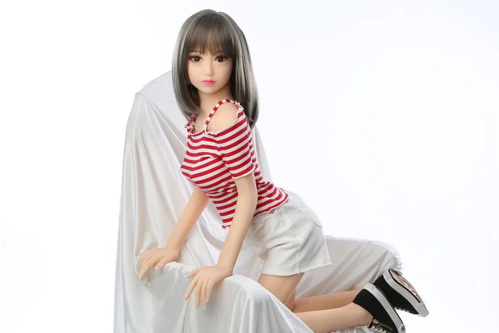 Sex doll with legs kneeling on the sofa