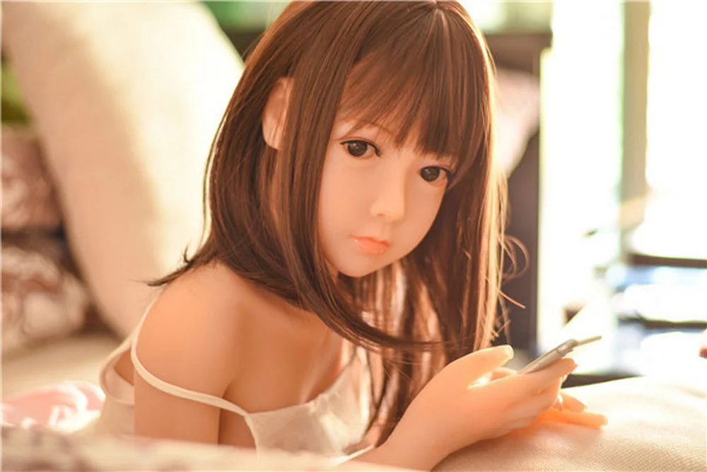 Sex doll with mobile phone in hand