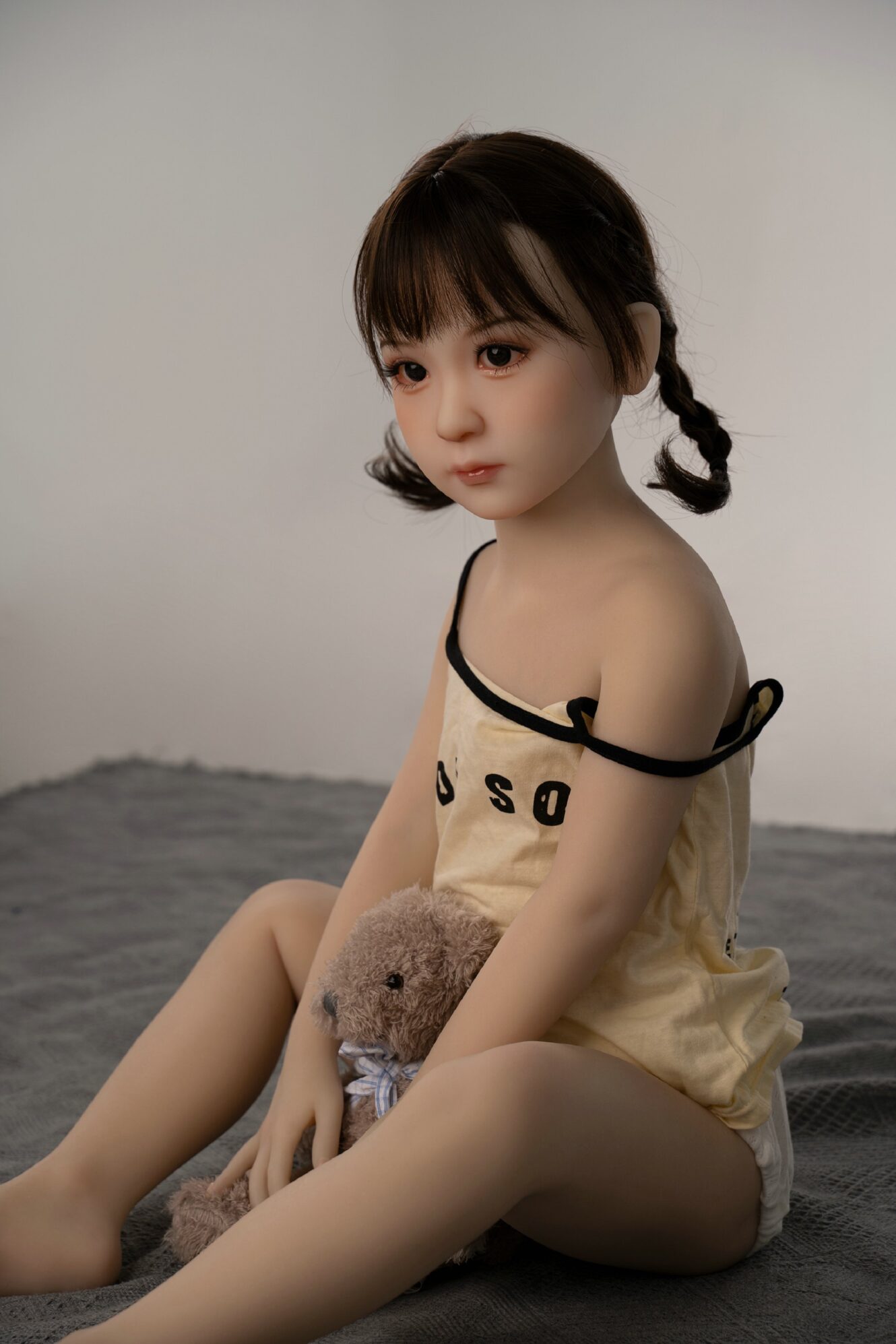 little sex doll sitting